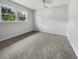 Empty bedroom with grey carpet, ceiling fan, and windows at 219 Owens Dr, Summerville, SC 29485
