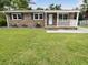 Brick ranch house with a white porch and well-manicured lawn at 219 Owens Dr, Summerville, SC 29485