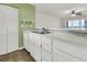 White kitchen cabinets, tile floor, and a view of the water at 100 Mariners Cay Dr, Folly Beach, SC 29439
