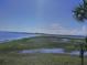 View of marsh and water from screened porch at 100 Mariners Cay Dr, Folly Beach, SC 29439