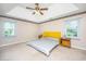 Spacious bedroom with carpeted floors, two windows, and a ceiling fan at 181 Pekoe Ct, Summerville, SC 29483