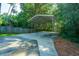 Covered carport with concrete parking area, nestled amongst lush greenery at 181 Pekoe Ct, Summerville, SC 29483