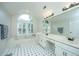 Bathroom with double vanity, large soaking tub, and arched window at 181 Pekoe Ct, Summerville, SC 29483