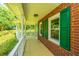 Inviting front porch with white railings and green shutters at 181 Pekoe Ct, Summerville, SC 29483