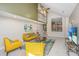 Bright living room with high ceiling, yellow couch and TV at 181 Pekoe Ct, Summerville, SC 29483