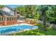 Home's backyard boasts a large, inviting pool surrounded by lush landscaping at 181 Pekoe Ct, Summerville, SC 29483