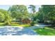 Brick home with a wrap-around porch, surrounded by mature trees at 181 Pekoe Ct, Summerville, SC 29483