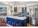 Modern kitchen with blue island, stainless steel appliances, and hardwood floors at 1637 Live Oak Park, Seabrook Island, SC 29455