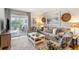 Cozy living room with a neutral sofa, patterned armchairs, and access to a balcony at 1637 Live Oak Park, Seabrook Island, SC 29455