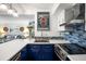 Modern kitchen with blue cabinets, stainless steel appliances, and a corner sink at 1637 Live Oak Park, Seabrook Island, SC 29455