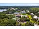Aerial view highlighting tennis courts, a clubhouse, and surrounding nature at 1637 Live Oak Park, Seabrook Island, SC 29455