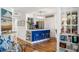 Modern kitchen with a blue breakfast bar, white countertop, and open shelving at 1637 Live Oak Park, Seabrook Island, SC 29455