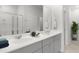 Double vanity bathroom with gray cabinets and a large mirror at 1020 Lovebug Ln, Summerville, SC 29485