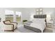 Spacious bedroom with a grey upholstered bed and a cream armchair at 1020 Lovebug Ln, Summerville, SC 29485