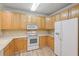 Light wood kitchen cabinets and white appliances at 1025 Riverland Woods Pl # 610, Charleston, SC 29412