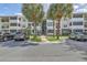 Apartment building exterior with parking and palm trees at 1025 Riverland Woods Pl # 610, Charleston, SC 29412
