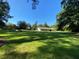 Large grassy backyard with various outbuildings at 1229 Central Ave, Summerville, SC 29483