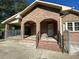 Brick house with a covered porch and yard at 1229 Central Ave, Summerville, SC 29483