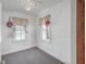 Small bedroom with gray carpeting and two windows at 380 Ashley Ave, Charleston, SC 29403
