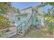 Backyard view of a light blue house with wooden stairs and AC unit at 380 Ashley Ave, Charleston, SC 29403