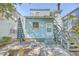 Backyard view showing a light blue house with stone patio and stairs at 380 Ashley Ave, Charleston, SC 29403