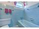 Retro bathroom with light blue tile and bathtub at 380 Ashley Ave, Charleston, SC 29403