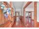 Long entry hall with hardwood floors and wood doors at 380 Ashley Ave, Charleston, SC 29403
