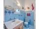 Retro bathroom with light blue tile and classic fixtures at 380 Ashley Ave, Charleston, SC 29403
