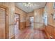 Long hallway with wood walls and floors, leading to other rooms at 380 Ashley Ave, Charleston, SC 29403