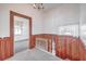 Upper hallway with wood walls, railing, and carpeting at 380 Ashley Ave, Charleston, SC 29403