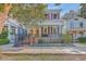 Charming two-story home with light blue siding, red shutters, and a brick walkway at 380 Ashley Ave, Charleston, SC 29403