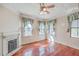 Charming bedroom with hardwood floors, fireplace, and large windows at 380 Ashley Ave, Charleston, SC 29403