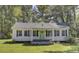 Charming white cottage with a light green door and black shutters at 1586 Highway 15, Saint George, SC 29477