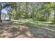 Yard with a white house, trampoline, and surrounding trees at 1586 Highway 15, Saint George, SC 29477