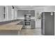 Updated kitchen with gray cabinets, stainless steel appliances, and wood countertop at 1586 Highway 15, Saint George, SC 29477