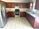 Galley kitchen with wood cabinets and stainless steel appliances at 506 Holiday Dr, Summerville, SC 29483