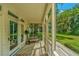 Relaxing screened porch with wooden flooring and views of lush greenery at 8083 Point Of Pines Rd, Edisto Island, SC 29438