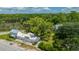 Aerial view of property showcasing main house, guest house, and waterfront access at 8083 Point Of Pines Rd, Edisto Island, SC 29438