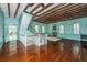 Open living space showcasing hardwood floors, exposed beams, and a staircase at 8083 Point Of Pines Rd, Edisto Island, SC 29438