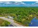 Aerial view of property with main house, outbuildings, and waterfront access at 8083 Point Of Pines Rd, Edisto Island, SC 29438