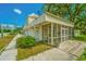 Charming historical building with a screened porch and well-maintained landscaping at 8083 Point Of Pines Rd, Edisto Island, SC 29438