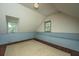 Charming attic bedroom with wood floors, built-in window seat, and sloped ceilings at 8083 Point Of Pines Rd, Edisto Island, SC 29438