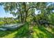 Small wooden deck situated near a bird feeder under a large oak tree at 8083 Point Of Pines Rd, Edisto Island, SC 29438