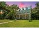 Historic home with wrap-around porch and lush landscaping at 8083 Point Of Pines Rd, Edisto Island, SC 29438