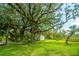 Small white outbuilding nestled under large oak trees with Spanish moss at 8083 Point Of Pines Rd, Edisto Island, SC 29438