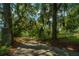 Stone pillars and gate leading to the home with lush landscaping at 8083 Point Of Pines Rd, Edisto Island, SC 29438