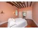 Bright bedroom featuring hardwood floors, exposed beams, and ample closet space at 8083 Point Of Pines Rd, Edisto Island, SC 29438