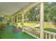 Charming porch with rocking chairs and view of yard at 8083 Point Of Pines Rd, Edisto Island, SC 29438
