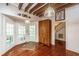 Kitchen with wood cabinets, exposed beams, hardwood floors, and access to a screened porch at 8083 Point Of Pines Rd, Edisto Island, SC 29438