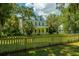 White house with green roof and picket fence at 8083 Point Of Pines Rd, Edisto Island, SC 29438